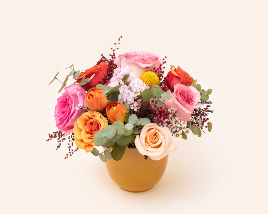 Arrangement of multicolored roses in ceramic